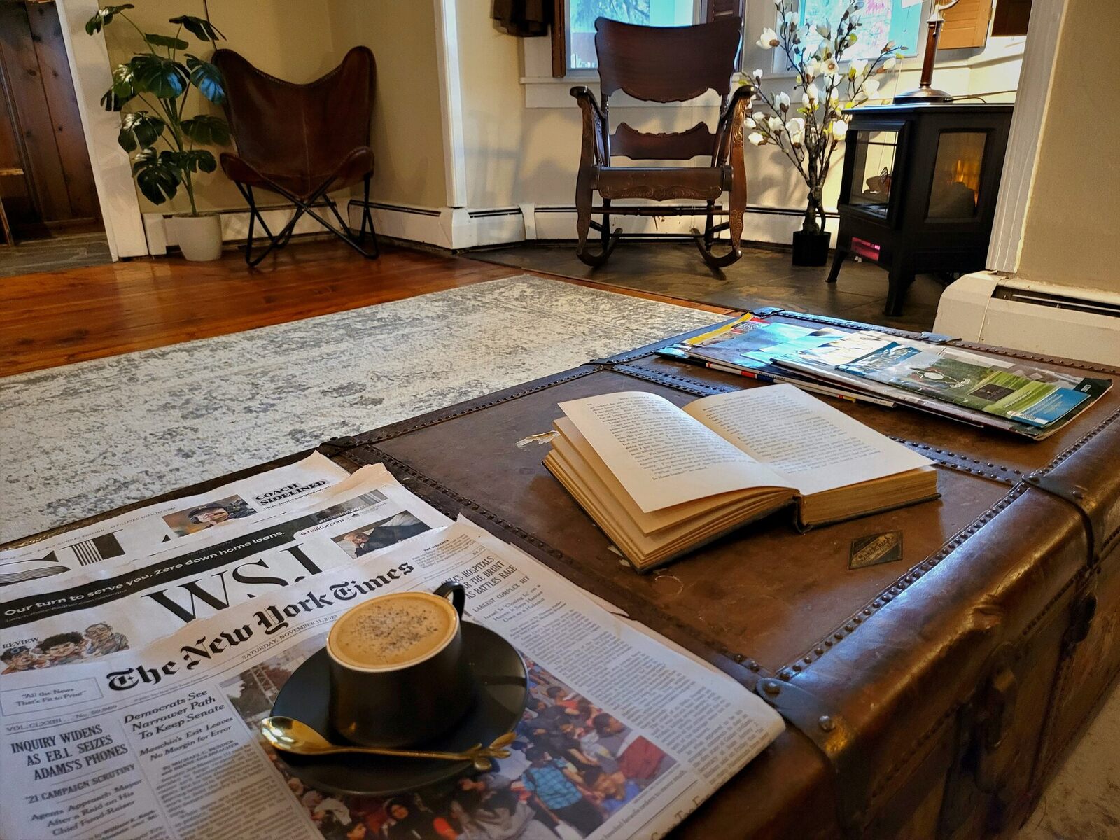 The morning newspapers and a coffee on an old leather trunk in the front foyer.